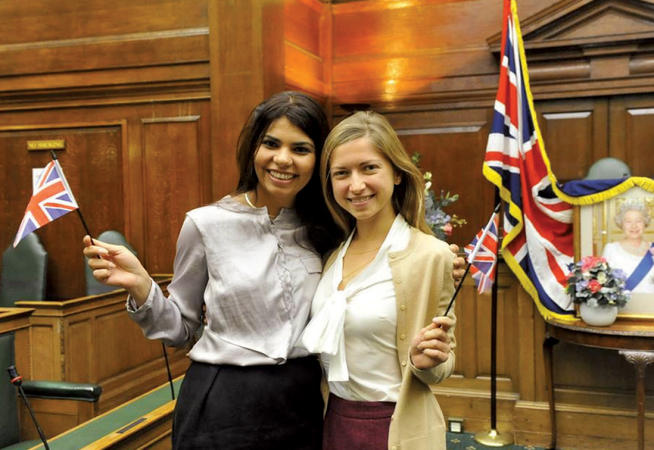 Ashleigh Silver ’04 (right) and friend Ambica Shiringi celebrate their newly minted British citizenship in summer 2013. Photo: Courtesy Ashleigh Silver ’04